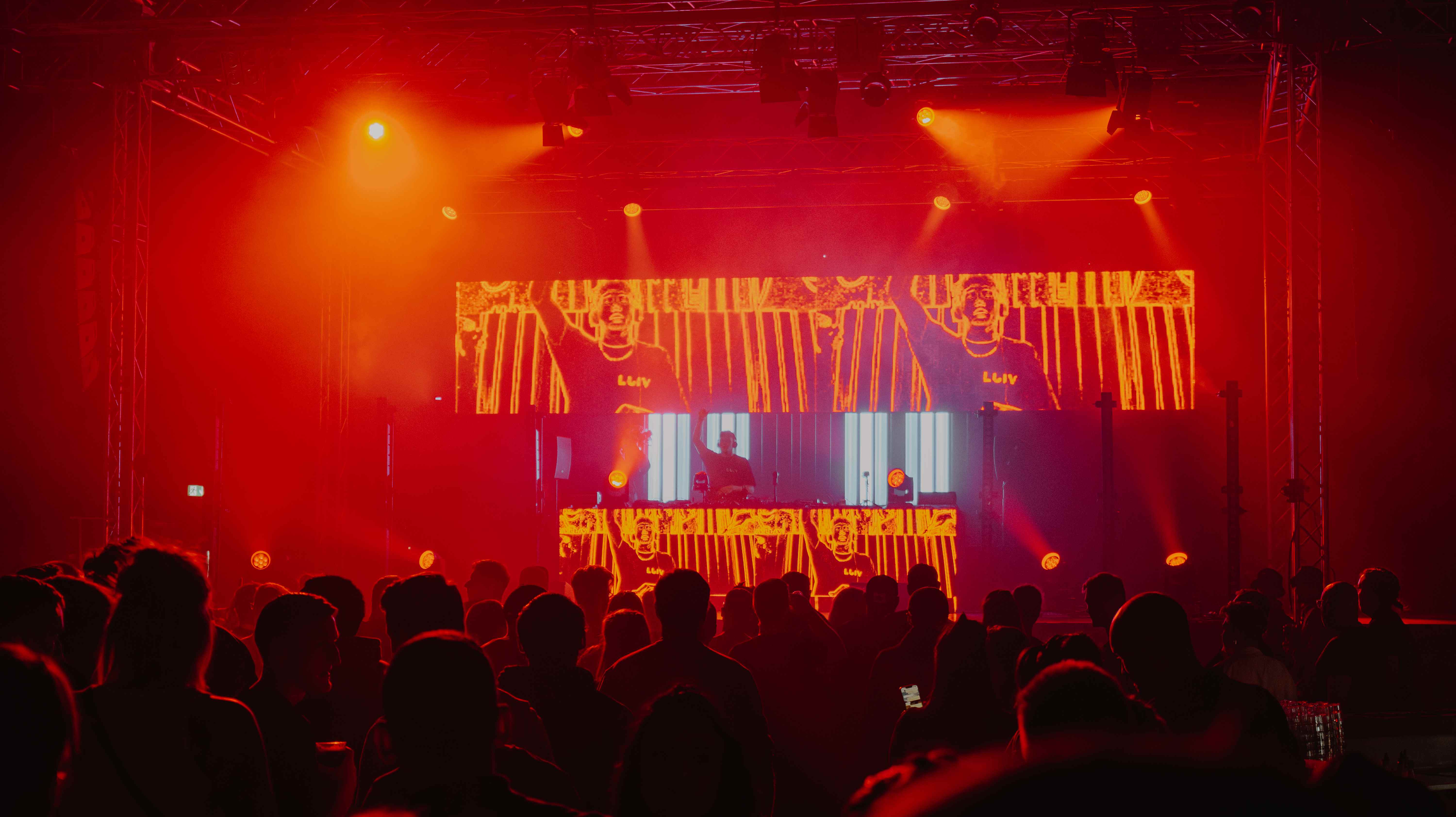 LUIV performing live — red stage lighting